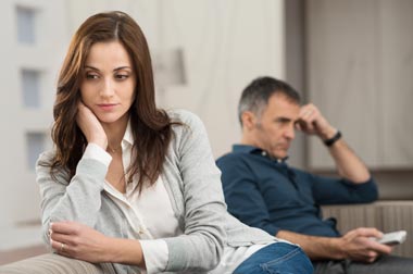 woman and man sitting on couch looking in different directions