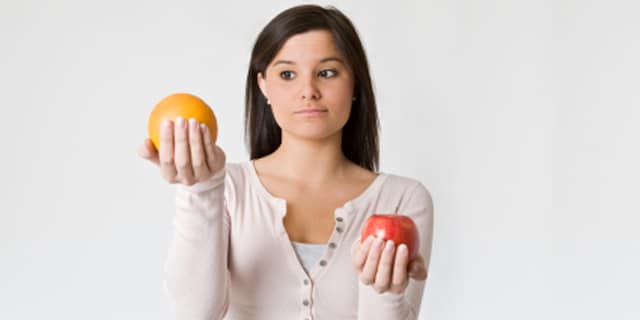 evaluation-of-alternative-to-legalzoom. Woman with apple and orange in hand.