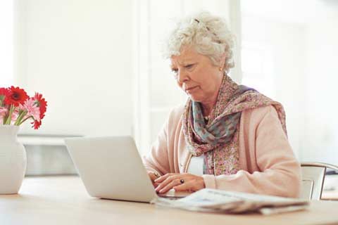 Elderly woman using laptop